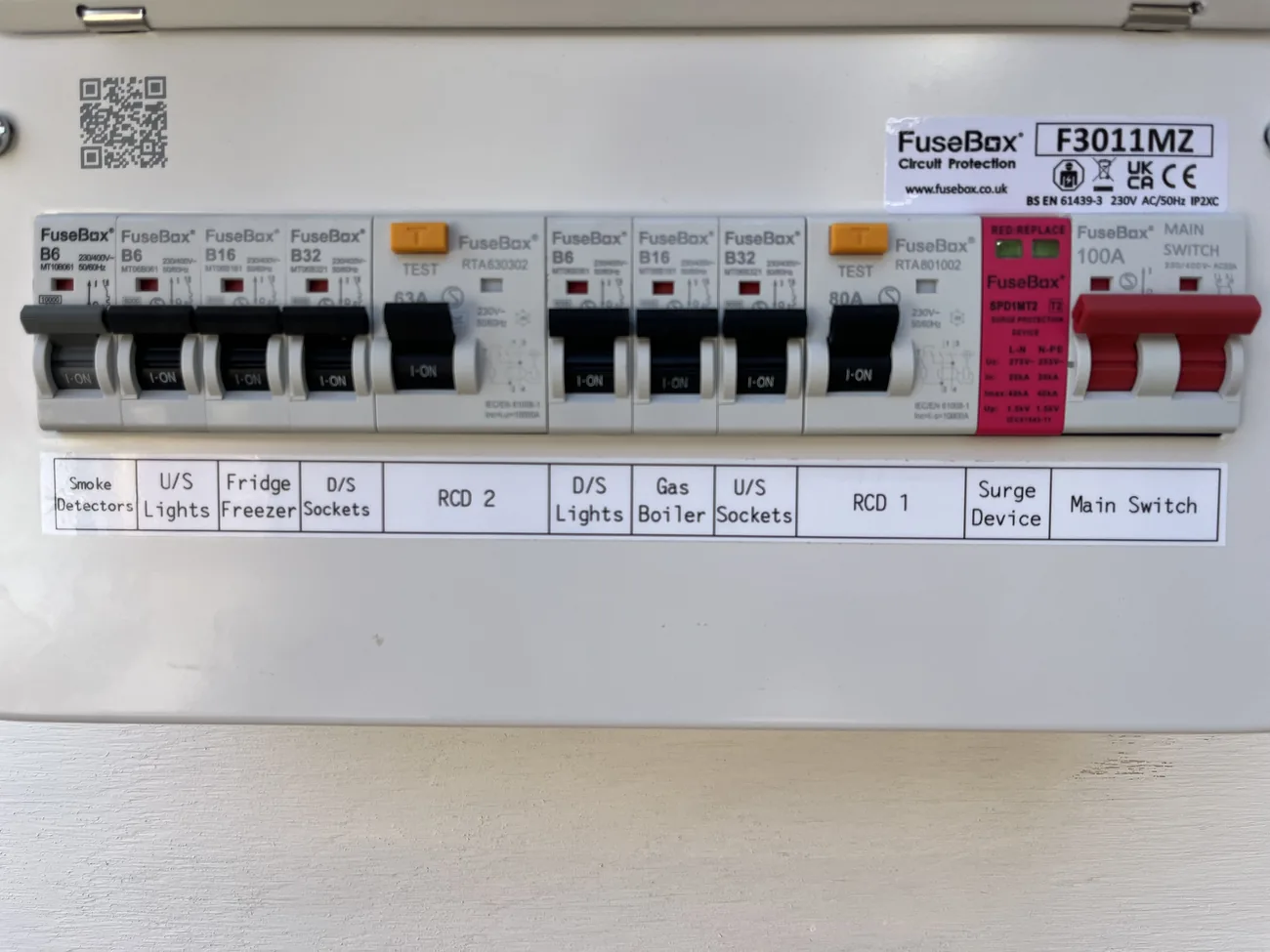 Split-load consumer unit with two RCDs, showing the orange RCD test buttons that mean modern shock protection